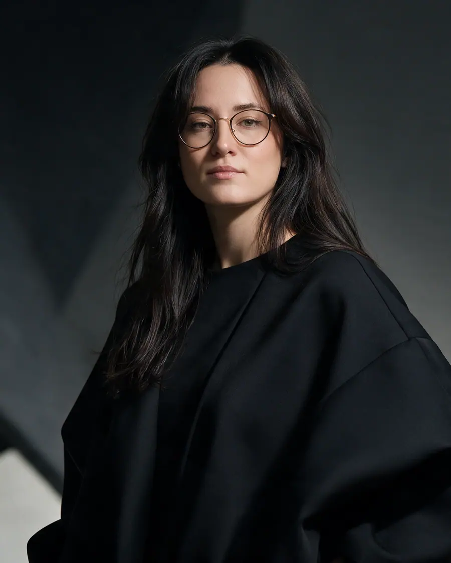 Editorial portrait of Catherine Tskho wearing black structured clothing.